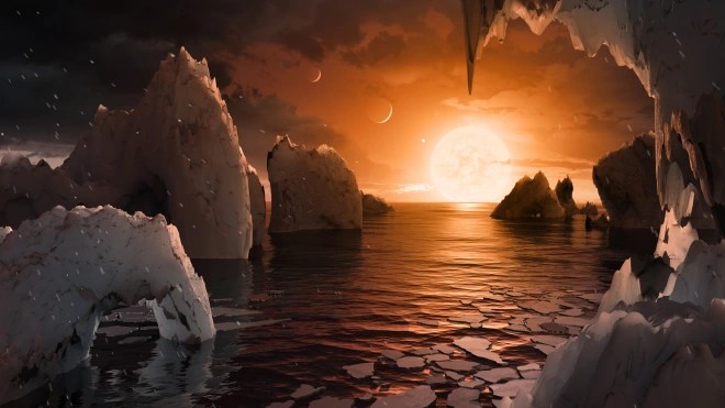 En este folleto de ilustración digital de la NASA publicado el 22 de febrero de 2017, el concepto de un artista nos permite imaginar cómo sería pararse en la superficie del exoplaneta TRAPPIST-1f, ubicado en el sistema TRAPPIST-1 en la constelación de Acuario. Debido a que se cree que este planeta está bloqueado por mareas con su estrella, lo que significa que la misma cara del planeta siempre apunta a la estrella, habría una región llamada terminador que divide perpetuamente el día y la noche. Si el lado nocturno está helado, el lado diurno podría dar paso a agua líquida en el área donde la luz de las estrellas llega a la superficie.